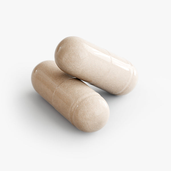 Two beige capsules on a white background
