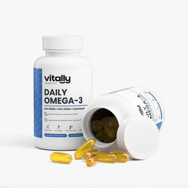 Vitally Essential Bioactive Daily Omega-3 supplement bottle shown upright with one tipped-over bottle and several yellow softgel capsules spilled in front, on a clean white studio background.