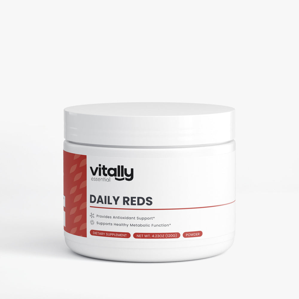 A white plastic jar of Vitally Essential Daily Reds powder supplement with a white lid, featuring a red and black label on a light gray background.